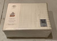 Packaged beige striped sateen duvet cover and sham set box with Whole Home logo and branding visible.