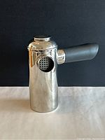 Front angled view showing the side filter port and black handle on the chrome French press.