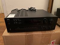 Full angled side view of the NAD C 720BEE stereo receiver showing power cable and top vents