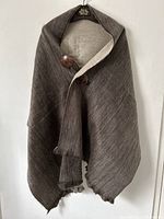 Front view of the alpaca blend buttoned cape showing color, fabric texture, and button placement.