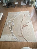 Full view of rug laid flat on floor showing overall pattern and color.