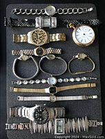 Full view of the 12 assorted watches including men's and women's wristwatches and a pocket watch, showcasing various materials and dial styles.