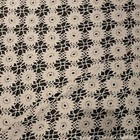 Close-up showing fine craftsmanship and floral motif lace details of the tablecloth