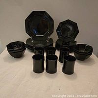Full set displayed showing 6 dinner plates, 12 side plates, 6 mugs, 6 bowls in black octagonal shape