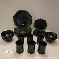 Full set view showing large plates, smaller plates, bowls, and mugs arranged on table.