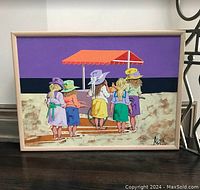 Front view of framed acrylic painting featuring five children on a beach with umbrella and purple sky.
