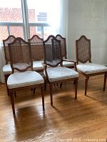 Group of six chairs in row near window