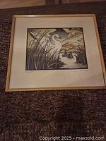 Framed print showing the full artwork and frame on a carpeted floor.