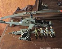 Photo of the helicopter and four action figures showing overall condition and scale.