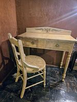 Full view of the antique Victorian writer's desk and matching chair showing the white painted finish, two drawers on desk, and chair with spindle back.