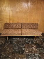 Front view of teak daybed with cushions in place