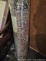 Rolled rug showing overall pattern and plastic packaging