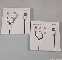 Two sealed white boxes labeled Moko Armor Magnetic Charging Cable 2-in-1 with a USB plug and magnetic charging pad illustrated on the front.