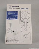 Front of box showing product name, Nest Cam compatibility, 360° swivel, 130° viewing angle and ability to mount Nest Cam directly to AC outlet without tools or wall damage.