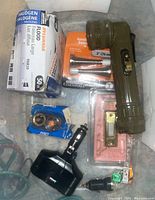 Overview of all items including flashlight, flood light bulbs, doorbell, fuses, lighter, and door stoppers.
