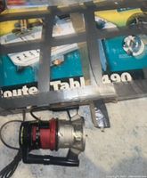 The Sears Craftsman handheld router and the boxed Wolfcraft Route Table 490 with visible tools and parts.