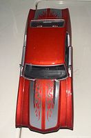 Top view of 1971 Chevy Chevelle die cast model, shows red paint with gray flames on hood.