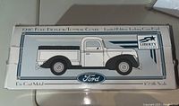 Original box showing illustration of 1940 Ford Pickup 1/25 scale model with branding and limited edition coin bank note.