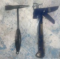 Photo of a metal ice pick with a coiled ribbed handle and a blue metal caulking gun on a speckled surface.