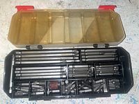Opened case showing meticulously organized 120-piece set of screwdriver bits, various sizes and types plus accessories