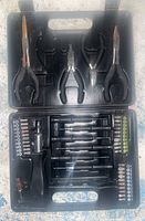 Plastic case open showing assorted pliers at top and screwdrivers and bits organized below