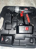Job Mate black and red cordless power drill with 18V battery, charger, and carrying case.