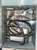 View of Rockwell Power Block Plane in metal case along with power cord and small accessory tools inside the case.