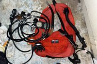 Photo showing scuba diving gear including buoyancy compensator and air hoses with attached regulators and gauges.