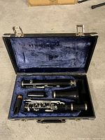 Open hard case with disassembled clarinet pieces inside