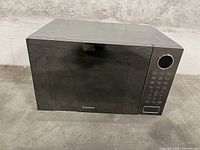Front and top view of Westinghouse microwave showing reflective black door and digital keypad with dial control.