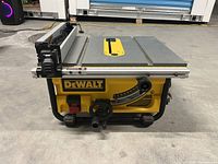 Front view of saw showing tabletop, rip fence, blade opening and bevel adjustment control