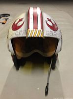 Front view of the Star Wars Rebel Pilot helmet showing the microphone and yellow visor