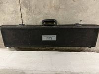 Closed black hard plastic carrying case with handle and latches