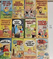 Photo of 13 Family Circus comic novels with front covers visible showing various cartoon covers