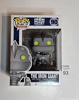 Front side of the Funko Pop box showing The Iron Giant figure with yellow eyes inside clear window packaging. Box labeled as number 90 in the series.