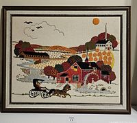 Frontal photo showing the full framed crewel embroidery artwork of a New England hillside scene.