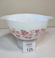 Pyrex Pink Gooseberry Cinderella mixing bowl front view with pattern visible, showing bowl supported on white foam.