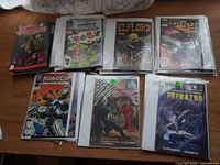 Photo showing a variety of comic books including Afterlife with Archie, The Muppets of Manhattan, Elflord, Zion, RoboCop, Dark Shadows, and Predator.