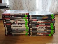 Stack of PlayStation 2 game cases showing the titles included in the lot