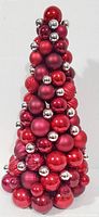Front view of 18.5 inch tall Christmas tree decoration made of red and silver ornaments in various sizes and finishes.