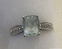 Top-down view showing cushion-cut aquamarine center stone and band detail