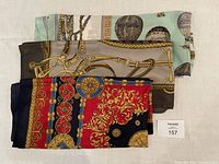 Three folded vintage polyester scarves stacked showing various colorful patterns.