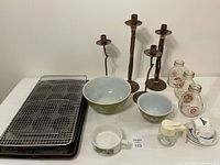 Photo showing the metal twig style candlesticks, milk jugs, Pyrex bowls, baking trays, and cooling rack arranged on a white surface.