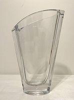 Frontal view of tall clear crystal vase showing angular shape and thickness.