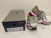 Complete lot photo showing the Asics shoe box and one shoe outside the box with tags visible, illustrating the new condition.