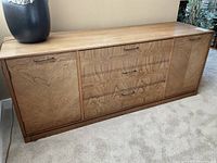 Front view of buffet showing full facade with two cabinets and three central drawers.