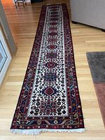 Full-length view of the rug runner laid on hardwood floor showing overall size and pattern.