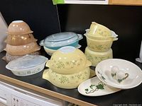 Overview of all Pyrex dishes and Poppytrail Ivy pieces on countertop, showing various colors and patterns