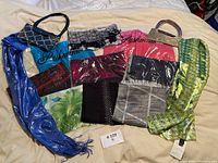 Full layout of scarves and handbags showing variety of colors, patterns, and textures.