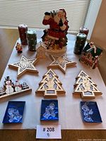 Full lot and arrangement on table including Santa cookie jar and Christmas themed decorations